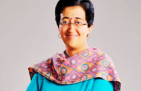 Atishi Marlena speaking at a public event, representing her work in education and politics.